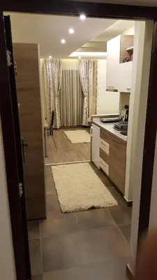 a kitchen with a door open to a kitchen with a counter at Apartman Mia Milmari in Kopaonik