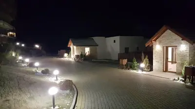a building with lights on the street at night at Apartman Mia Milmari in Kopaonik