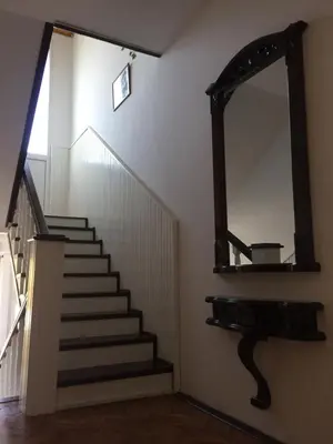 a stairway with a mirror and a stair case at Pansion 