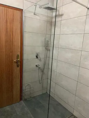 a bathroom with a shower with a glass door at Pansion 
