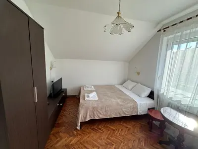a small bedroom with a bed and a window at Pansion 