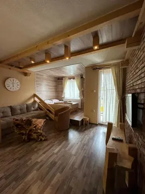 a living room with a couch and a clock on the wall at Apartments Park 2016 in Surdulica
