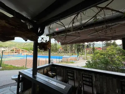 a balcony with a table and a view of a playground at Apartments Park 2016 in Surdulica