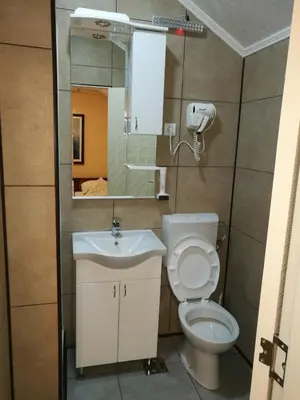 a bathroom with a toilet and a sink at JOKSIM Rooms&Restaurant in Kuršumlija