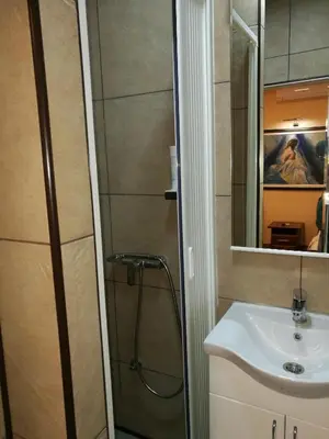 a bathroom with a shower and a sink at JOKSIM Rooms&Restaurant in Kuršumlija