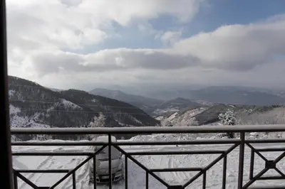 a view of the mountains from a balcony with snow at Apartment Milmari Sunny View G3 in Kopaonik