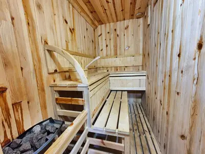 a wooden sauna with a chair in the middle at Vila Dizdarevic Kopaonik in Kopaonik