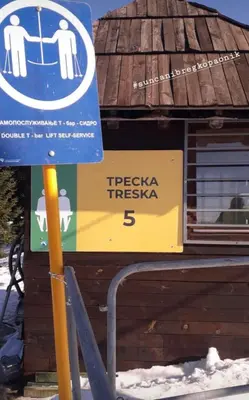 a blue sign in the snow next to a building at Vila Dizdarevic Kopaonik in Kopaonik
