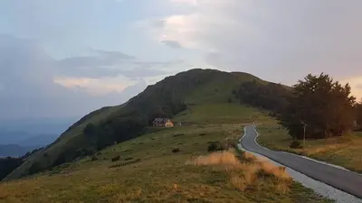 a winding road on a hill with a mountain at Vila Dizdarevic Kopaonik in Kopaonik