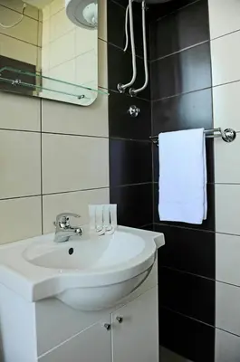 a bathroom with a white sink and a mirror at Sunny Kop Čardaci in Kopaonik