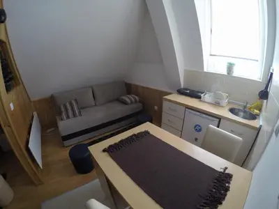a small living room with a couch and a table at Sunny Kop Čardaci in Kopaonik