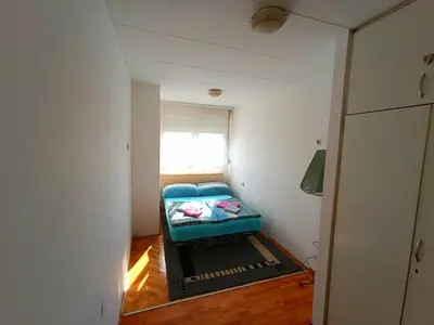 a small room with a small bed in the corner at Studio Ema in Niš