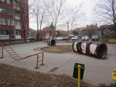 a playground with two large tires in a park at Studio Ema in Niš