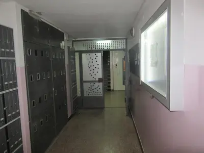 a hallway with lockers and a door in a room at Studio Ema in Niš