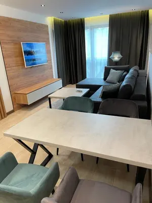 a living room with a couch and a table at Vip Apartments Kopaonik in Kopaonik