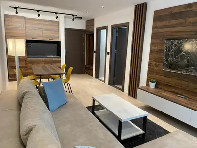 a living room with a couch and a table at Vip Apartments Kopaonik in Kopaonik