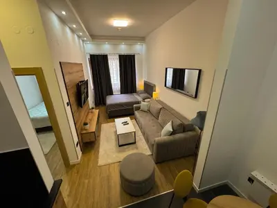 a living room with a couch and a table at Vip Apartments Kopaonik in Kopaonik