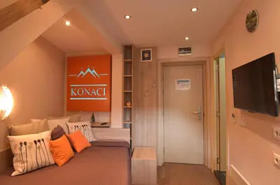 a living room with a couch and a flat screen tv at Apartment Ski Star Konaci in Kopaonik
