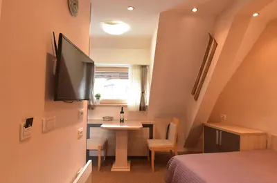 a small room with a small table and a television at Apartment Ski Star Konaci in Kopaonik
