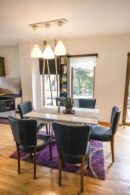 a dining room with a table and chairs at Lodge Zeleni svet in Crni Vrh