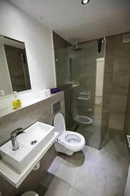 a bathroom with a toilet and a sink and a shower at Apartment Azulmburgo in Vrnjačka Banja