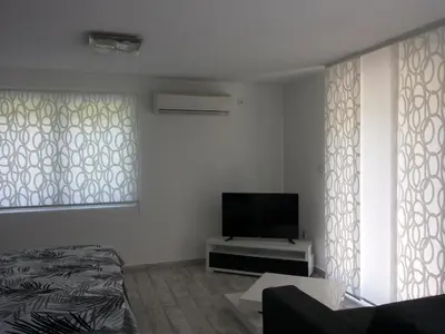 a living room with a flat screen tv and a couch at Apartment Azulmburgo in Vrnjačka Banja