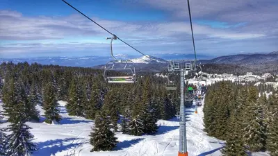 a ski lift on a ski slope with trees at Apartments Zed Vila Zvoncica in Kopaonik