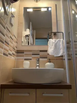 a bathroom sink with a large mirror above it at Apartment Koko in Kopaonik