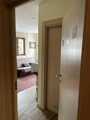 a room with a door open to a living room at Apartment Koko in Kopaonik