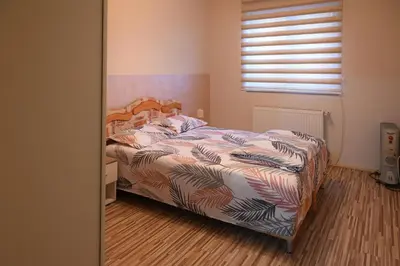 a bedroom with a bed and a window at MB Apartments in Jagodina