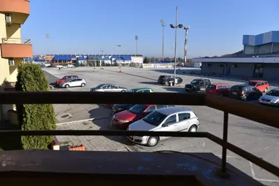 a parking lot with cars parked in a parking lot at MB Apartments in Jagodina