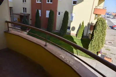 a balcony with a railing and trees and buildings at MB Apartments in Jagodina
