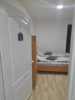 a door leading to a bedroom with a bed at Guest House Vila Banjica in Pirot