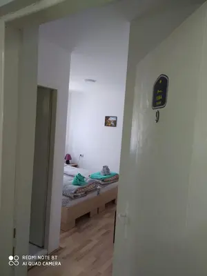 a bedroom with a bed in a room with a doorway at Guest House Vila Banjica in Pirot
