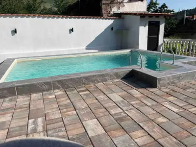 a swimming pool in a yard with a house at Guest House Vila Banjica in Pirot