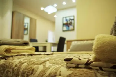 a bedroom with a bed with a teddy bear on it at Square Studio Apartment in Niš