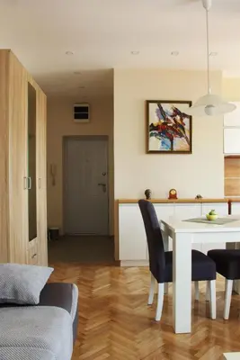 a kitchen and dining room with a table and chairs at Square Studio Apartment in Niš