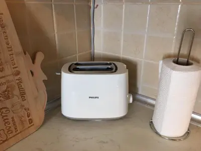 a white toaster next to a roll of paper towels at Apartment Marija- Kopaonik centar in Kopaonik