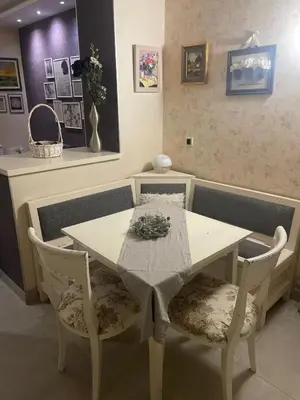 a table and two chairs with a white table and a table and chairsuggest at Apartment Marija- Kopaonik centar in Kopaonik
