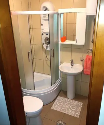 a bathroom with a shower and a toilet and a sink at Apartmani Tamara in Vrnjačka Banja
