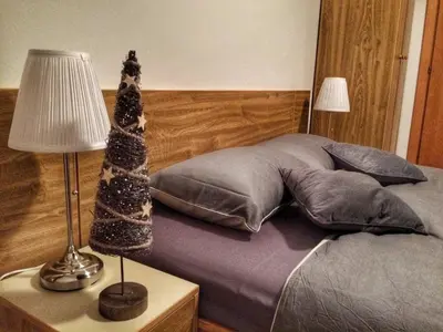 a bedroom with a bed with a lamp and pillows at KOP Centar Aviator in Kopaonik