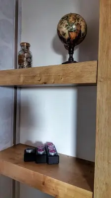 a shelf with two cell phones and a globe on it at KOP Centar Aviator in Kopaonik