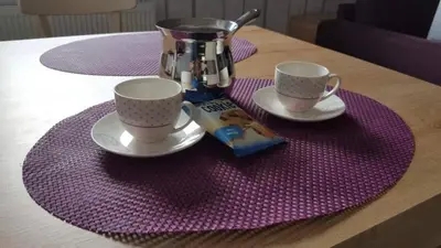 a table with two coffee cups and a juicer at KOP Centar Aviator in Kopaonik