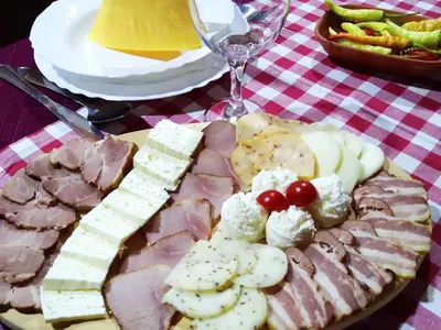 a plate of food with meat and cheese and grapes at 