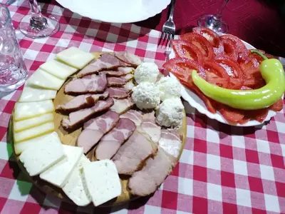 a plate of food with meat and vegetables on a table at 
