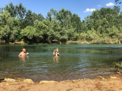 a man and a woman swimming in a river at 
