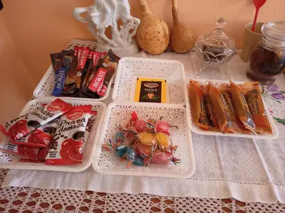 a table with three trays of food and other items at 