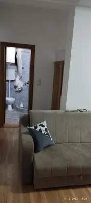 a living room with a couch and a mirror at Dobricin Konak Apartmani in Kopaonik
