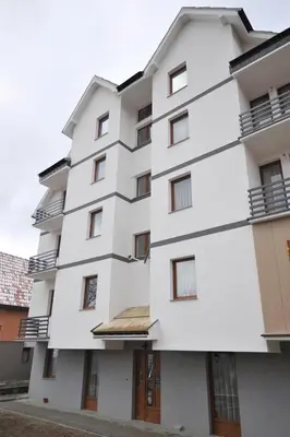 an image of a white building at Dobricin Konak Apartmani in Kopaonik