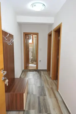 an empty room with a door and a hallway at Dobricin Konak Apartmani in Kopaonik